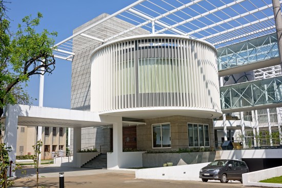 The circular mass is the conference room  & glass bridges are connecting passages  between north & south wings. Pergolas are designed in such a way that it creates shadows   over courtyard. 
