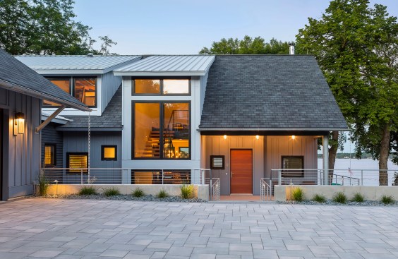 Closer view of newly built A-frame house on lake