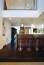 The home’s interiors reflect the contemporary exterior aesthetic, with salvaged oak flooring, reconstituted wood veneer cabinetry, and recycled glass terrazzo countertops.