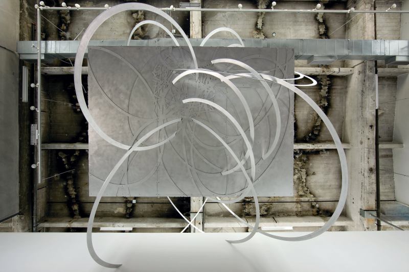 "Architecture needs an enemy," says Eric Owen Moss. The Los Angeles designer nominates the ubiquitous grid and binds it in "If Not Now, When?," an installation on view at SCI-Arc through Sept. 13. Visitors are invited to gather under an aluminum box wrapped by plasma-cut aluminum ribbons and suspended from the ceiling (thanks to engineering consultation from Buro Happold).

sciarc.edu