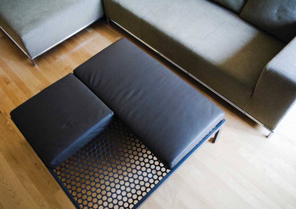 Alla Kazovsky Architects' new Perforations line of furniture and accessories explores the use of perforated steel paired with other materials to make versatile pieces. Featuring end tables, conference tables, partition screens, and sculptures, the collection celebrates the two-sided nature of the material. Each product can be used in multiple ways and material combinations. The On the Level coffee table (shown) is made up of rectangular steel tubing and a sheet of perforated steel. It can also be used as an ottoman when the accompanying square and rectangular leather cushions are added.

designedrealestate.com