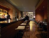 The new Tiny Lounge packs a lot into a 2,000-square-foot package. Several distinct table-seating areas (high-top tables, banquet seating, and booths) maintain an intimate feeling, while floor-to-ceiling glass doors capture as much daylight as possible for the after-work crowd.