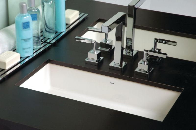 The Undermounted Vanity Rectangular Lavatory sink, shown here with the polished-chrome Quadratta Lavatory Mixer faucet, is the latest basin from Duratex brand Deca. The fire-clay sink delivers a streamlined, modern look well suited for hospitality environments. Measuring 23 1/4" long by 9 1/16" wide by 6 5/16" deep, the basin also features overflow prevention. deca-us.com