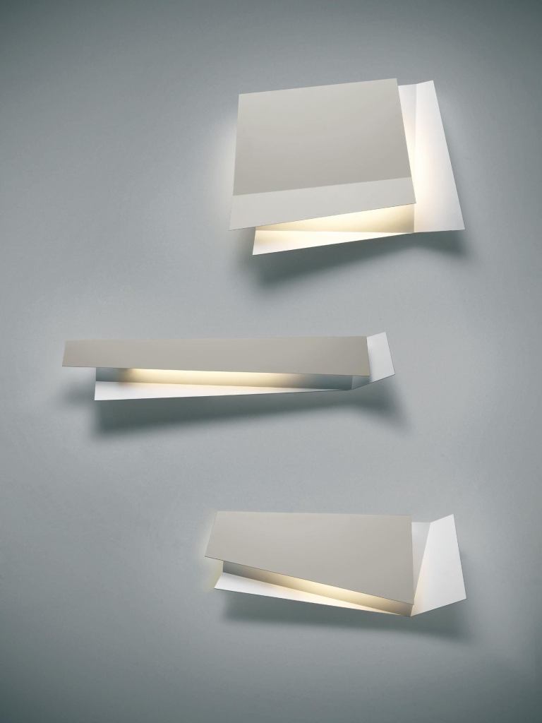 Flap from Foscarini calls to mind a contemporary art piece with irregular geometric lines. It decorates walls with a mix of light and shade formed by the fixtures two overlapping metal surfaces, which have a slight bend and irregular overlay. When lit, Flap creates a perception that there are four surfaces, due to backlit shadows that are projected on the wall. Several Flap fixtures can be specified together to create an eye-catching light sculpture for both residential and contract applications. Three sizes are available. The fixture is made of lacquered aluminum and lamped with two 18W fluorescent bulbs. foscarini.com