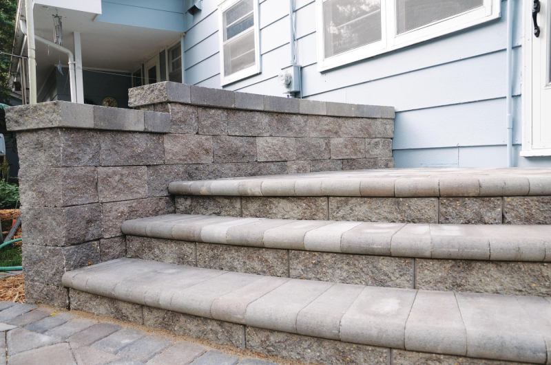 Versa-Lok top-pinning segmental retaining wall system is now available in a bronze blend color. The concrete system is finished in either a traditional split-face or a vintage weathered texture and readily accommodates soil reinforcement to build walls 50' or taller. It can be used to build walls, curves, multi-angle corners, stairs, and freestanding walls and columns. No specialty pieces are required, and no hollow cores are created to be filled. Versa-Lok is available in several options, including Standard, Cobble, Accent, random-pattern Mosaic, Mosette, Brute, Bronco, Square Foot, and Versa-Green (which is plantable). versa-lok.com