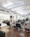 To create an inviting but understated space for the Bradley & Diegel Salon, Studio Luz Architects created a series of sculptural lightboxes to emulate existing skylights, and to infuse the long, linear space with more natural light.