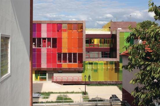 KOZ The brightly glazed Youth Center and Sports Complex in Saint-Cloud, France, is constructed from an articulated ribbon of stuctural, load-bearing, prefabricated concrete panels. This allowed for quick construction and was an experiment for Paris-based KOZ Architects, which had not previously worked with the material