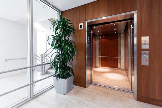 Custom LEVELe-101 Elevator Interior with custom main inset panels; outer accent panels in ViviChrome Chromis glass with Mirror Mist interlayer and Opalex finish; inner accent panels in Stainless Steel with Seastone finish and Kalahari pattern at MIT - Massachusetts Institute of Technology, Cambridge, Massachusetts