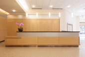 Reception desk and wall accents in ViviChrome Chromis glass with Taupe interlayer and Opalex finish at Lloyd Center Tower, Portland, Oregon