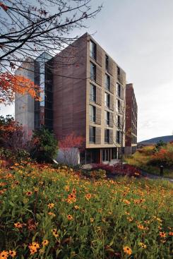 Located in the Berkshires, the new dormitory building at the Kripalu Center for Yoga & Health is a study in wood, glass, and concrete. Cypress cladding runs the length of the fa?ade, and matching strips are worked into manually operated window shades for each guest room.