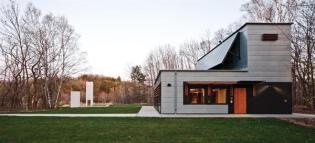 The building was designed with Passivhaus principles, with heating primarily by direct passive solar gain from the south, and internal heat gain from equipment and occupants.