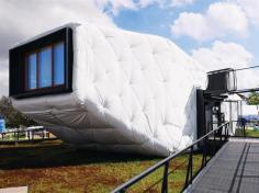 The house features an exterior skin made of 14 to 16 inches of denim batt insulation wrapped with a low-cost, engineered, vinyl-coated polyester fastened with zip ties, dowel rods, and lag screws.