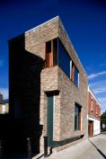 Play on weight of brick as it turns to address the laneway
