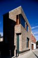 Play on weight of brick as it turns to address the laneway