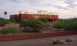 The copper-clad South Mountain Community Library is capped by five glazed volumes that admit daylight and serve as lanterns at night.