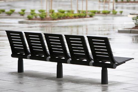 Tecno RS Seating System shown in five-seat, backed configuration with Black Texture powdercoated frame and seats, Silver Texture powdercoated angled armrests, and cylindrical mounting posts at Sound Transit, Seattle, Washington