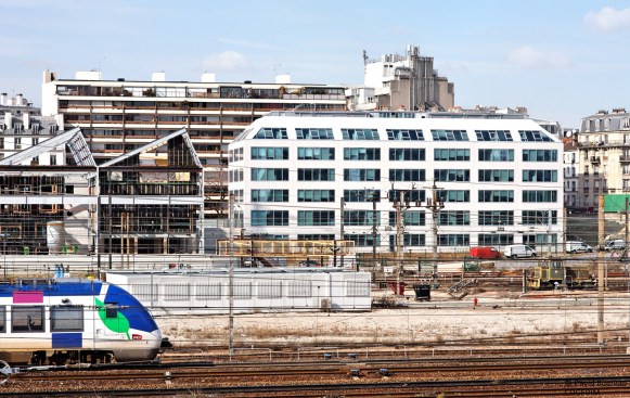 The ZAC PAJOL offices occupy a former industrial site adjacent to rail lines in the 18th arrondissement of Paris.