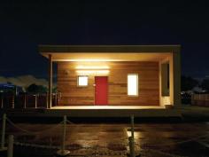 The house features a welcoming front porch, a private back porch with storage space, and an interior flex space that incorporates built-in shelving.