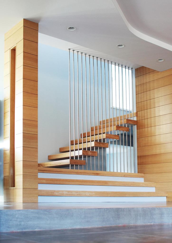 Stainless steel rods provide deceptively solid support for a stair that seems to float in space.