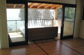 The bed rolls out onto a sheltered, screened porch so the owners can "camp out" even on buggy or stormy nights.