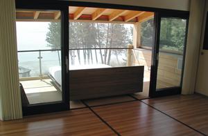 The bed rolls out onto a sheltered, screened porch so the owners can "camp out" even on buggy or stormy nights.
