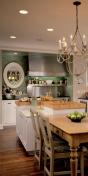 The oval window next  to the stove lets light pass through the interior wall. Placement of the window also marks the cneter line along which the main living spaces  dining, kitchen and family are aligned.