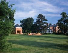 The pool pavilion sits on direct axis with the main house and both buildings overlook Leeds Creek. Old growth trees were preserved and screen views between house and pavilion while a brick pathway with a large dining terrace to one side links the two structures.