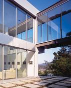 The exterior walls are made of limestone on the lower portion and are finished with smooth plaster on top. Limestone louvers create light shelves that let in winter sun. Inside, first-floor living spaces float free of the perimeter walls.