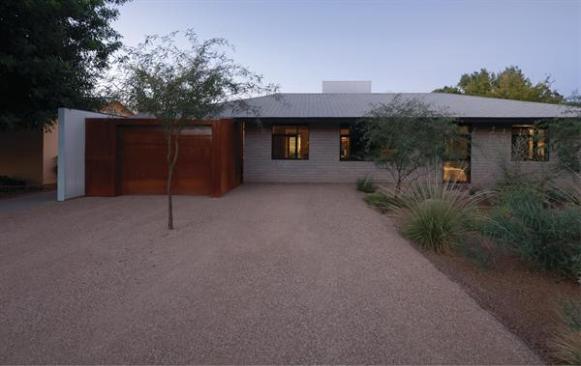 The street-front of this remodeled 1950s ranch retains much of its original identity.