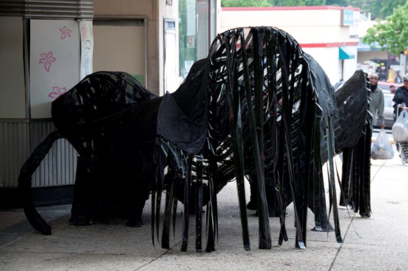 Movie Cave &nbsp;Located in front of the long-defunct Flower Theater, which itself is the subject of an ongoing series of charrettes aiming for revitalization, the Movie Cave is a dark, parametrically designed sculpture covered in strips of film. The materials look opaque from without, but once you crawl inside, the backlit strips are revealed to be actual film from a reel containing one of the films in the Twilight series. The experience is completed by an auditory component: a looped track of movie theme songs playing from a hidden speaker inside the boarded-up ticket booth. “It looks like a wood mushroom,” Grenier says, noting that he enjoys the fact that “this is a dead theater and now there’s something growing out of it.”