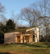 On approach, the sod roof tips up, preserving the buildings scale while allowing for head clearances upstairs.