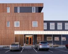 The Finn Lofts orange entry doors add a touch of bright color to the exteriors.