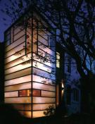To bring light to this dark row house, David Jameson, AIA, inserted 1 1/4- inch-thick acid-etched glass into a thin-profile steel volume. Transparent vertical glass panels permit views to the rear and sides of the site.