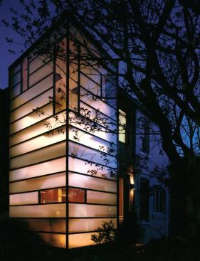 To bring light to this dark row house, David Jameson, AIA, inserted 1 1/4- inch-thick acid-etched glass into a thin-profile steel volume. Transparent vertical glass panels permit views to the rear and sides of the site.