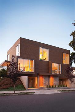 To capture natural light, this duplex stretches on an east west axis and elevates its main living spaces above street level.