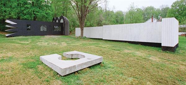 Sited within view of a road and nearby homes, this transformed ranch house will give the neighbors plenty to talk about.