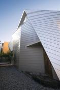 Galvanized steel-faced sandwich panels wrap the building in a modern skin.
