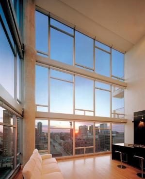 Inside, rough exposed concrete pillars complement refined hardwood floors.