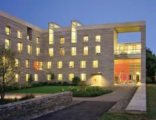 The two modern builds integrate two unique features of the campus: stone and the landscape's function as an arboretum.