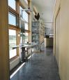 Clad in limestone panels and corrugated metal, the house hugs the contours of the landscape.