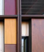 Alternating layers of glass, unfinished cedar, and glossy Prodema give the facade a dynamic quality.