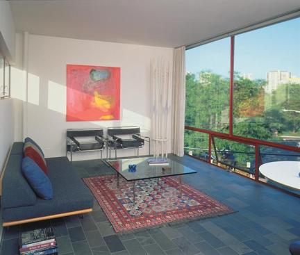 Living room, dining room, and kitchen function as one space. Slate floor tiles laid with a very thin mortar joint contribute to the houses sense of delicacy.