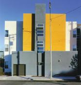 Colored stucco helps fragment the design as it moves back from the main avenue.