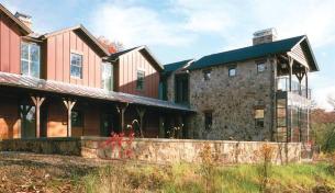 The exterior materials of this weekend retreat wrap to the interior, reinforcing its theme of refined rusticity.