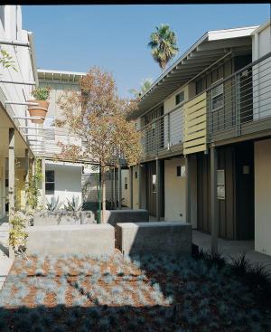 Each unit has a deck or French doors and a kitchen overlooking the sunlit courtyard. Low walls offer a place to hang out while waiting for the laundry. Shielded light sources and tree uplights create a residential feel.