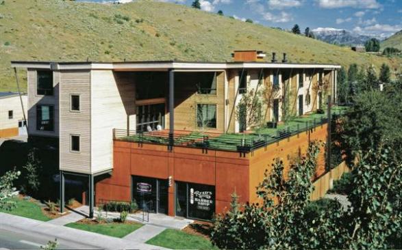 An acid-based stain gives the building's concrete base a terra-cotta coloring to better blend with its surrounding landscape. 