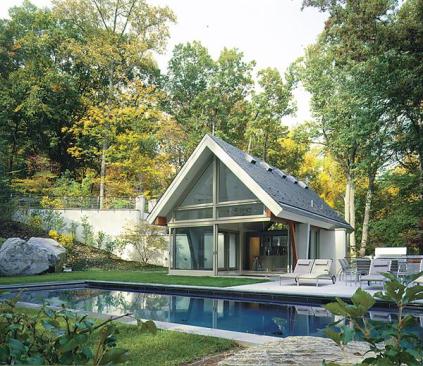 The peaked roof on this pool house mimics that on the main residence.