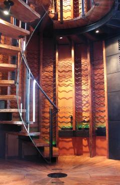 A spiral staircase leads to a rooftop deck and stunning views.