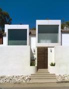 The reinterpreted bay windows gesture to the street, bringing light to the master suite and hiding the tile roof lurking in the back.