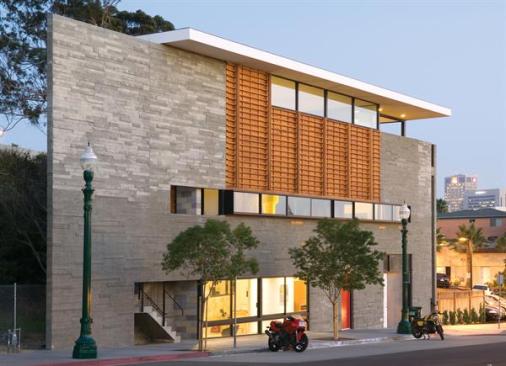 Outside, the oiled Douglas fir cladding is meant to evoke the memory and beauty of the wood formwork used to make the concrete walls what Russell calls handmade modernism.
